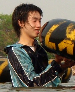 wet anorak boy splashes in lake fully clothed